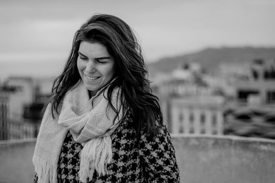 Portrait of beautiful young woman against sky