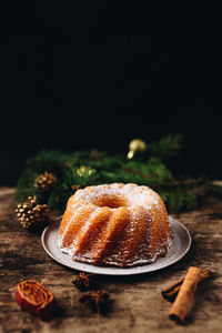 Close-up of cake on table against black background