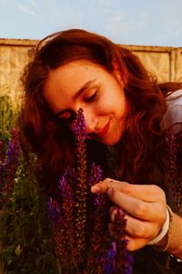 Beautiful young woman with purple flower