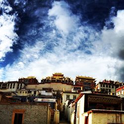 Buildings against cloudy sky