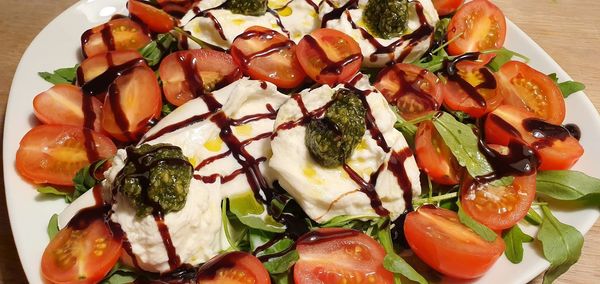 High angle view of chopped vegetables in plate on table