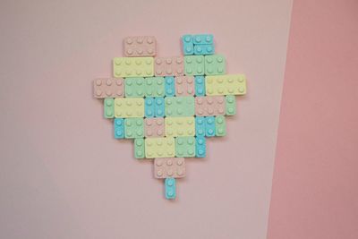 High angle view of heart shape made from plastic blocks on table