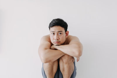 Portrait of young man against white background