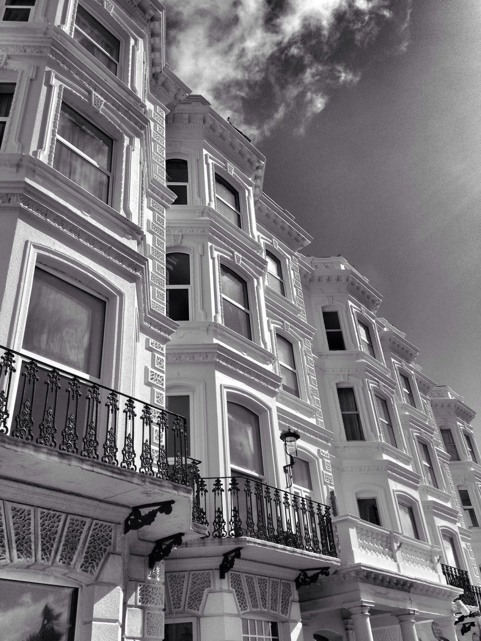 architecture, built structure, building exterior, low angle view, sky, window, building, cloud - sky, residential building, cloudy, residential structure, city, old, day, outdoors, no people, cloud, history, facade, glass - material