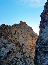 Low angle view of rocky mountains against clear sky