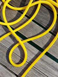 Close-up of yellow hose on table
