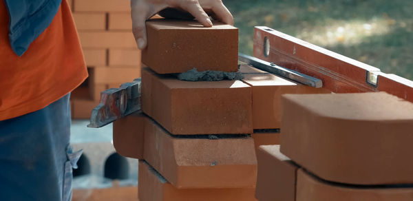 Close-up of man with umbrella standing in box