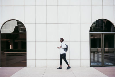 Man standing against building in city