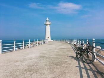 View of lighthouse on beach against sky