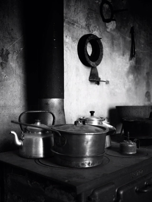 indoors, still life, table, coffee cup, metal, close-up, drink, no people, kitchen utensil, domestic kitchen, cup, food and drink, home interior, old-fashioned, coffee - drink, container, wall - building feature, handle, sink, saucer