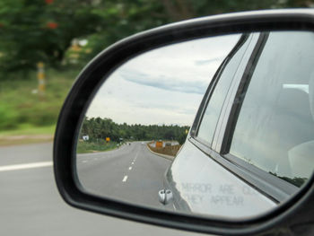 Reflection of car on side-view mirror