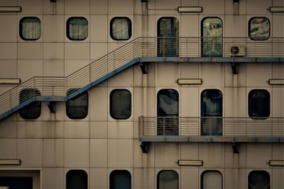Low angle view of handrails and windows on seaship.