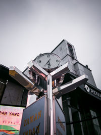 Low angle view of clock tower against sky in city