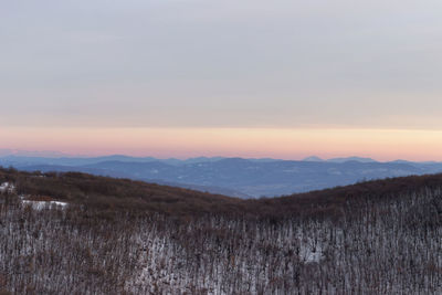 Scenic view of field against sky during sunset