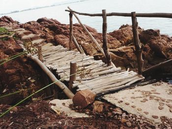 Wooden log on shore by sea