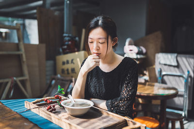 Young woman sitting at table