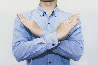 Midsection of man standing against white background