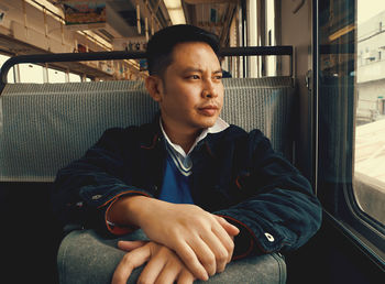 Young man sitting in train