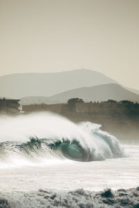 Waves on sea against sky