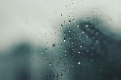 Close-up of wet glass window during rainy season