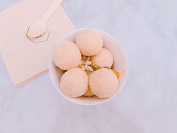 High angle view of ice cream in bowl with tissues on table