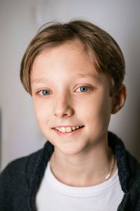 Cute little boy in white t-shirt and black sweater posing. portrait