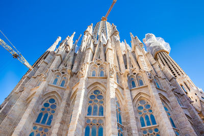 Low angle view of temple building against blue sky