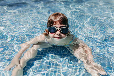 Portrait of man swimming in pool