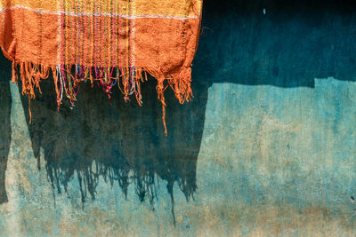 Close-up of clothes drying against blue wall