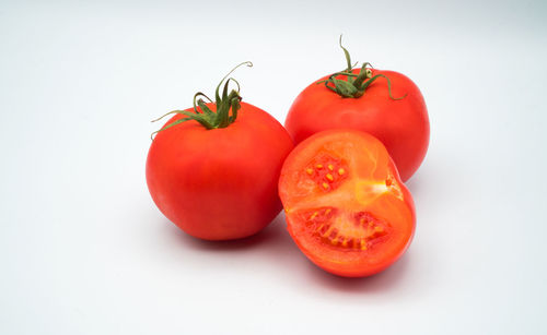 Close-up of tomatoes against white background