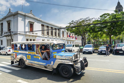 View of cars on road in city