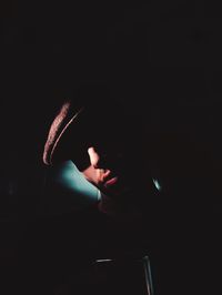 Close-up of hand holding sparkler in darkroom