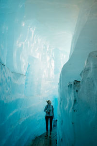 Full length of man standing on frozen sea during winter