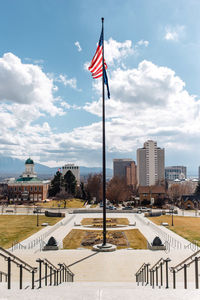 Flag in city against sky