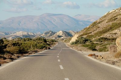 Road amidst mountains against sky