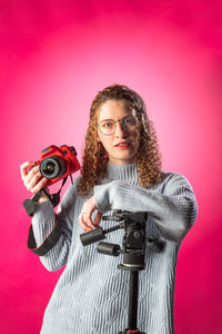 Portrait of woman with camera