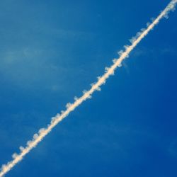 Low angle view of vapor trails in sky