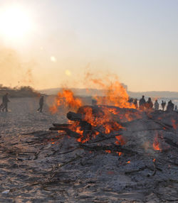 Bonfire at beach during sunset