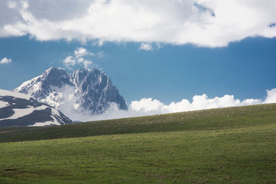 Scenic view of snowcapped field against sky