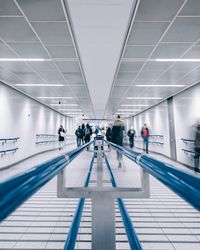 People walking in corridor of modern building