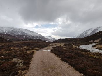 Scenic view of mountains against cloudy sky