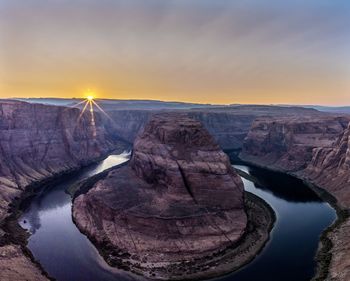 Scenic view of horseshoe bend, page az against sky during sunset