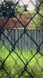 Full frame shot of chainlink fence against sky