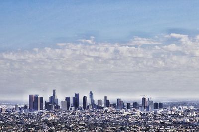 Aerial view of modern buildings in city against sky