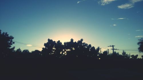 Low angle view of silhouette trees against sky at sunset