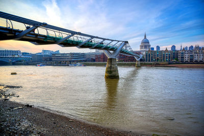 Bridge over river with city in background