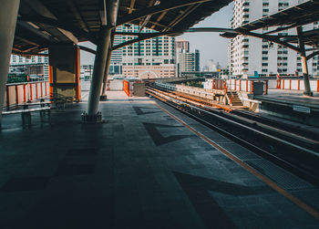 Railroad tracks in city against sky