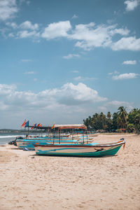 Boats in sea against sky