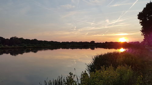 Scenic view of lake against sky during sunset