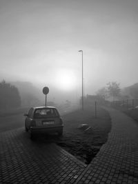 Cars on road in city against sky